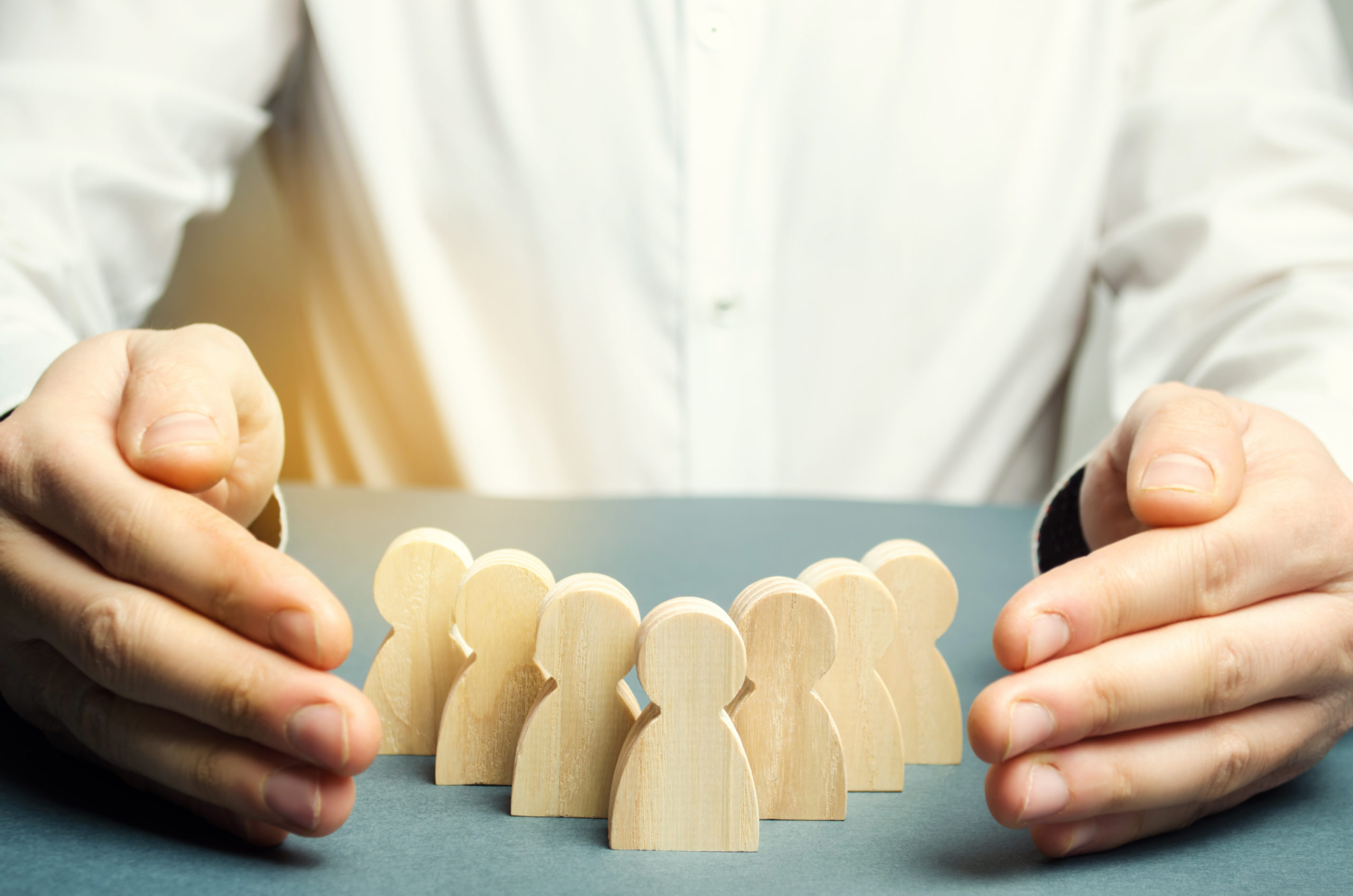 Boss defending his team with a gesture of protection. Life insurance. Customer care, care for employees. Security and safety in a business team. Human resources. A responsibility. Social protection Boss defending his team with a gesture of protection. Life insurance. Customer care, care for employees. Security and safety in a business team. Human resources. A responsibility. Social protection
