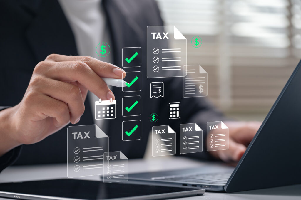Business tax management concept. businessman using digital interface to manage online tax filing with checklist, documents, and calendar icons over laptop for financial planning and compliance.