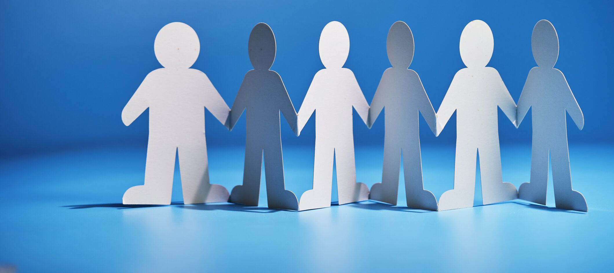 Paper chain paper people holding hands for teamwork concept