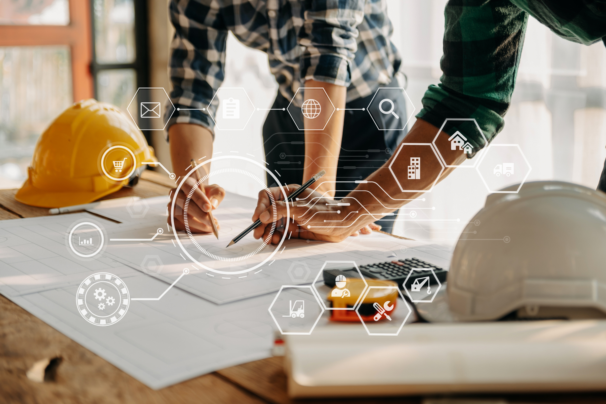 Two construction workers reviewing blueprints on a table with yellow and white hard hats, overlaid with digital technology...