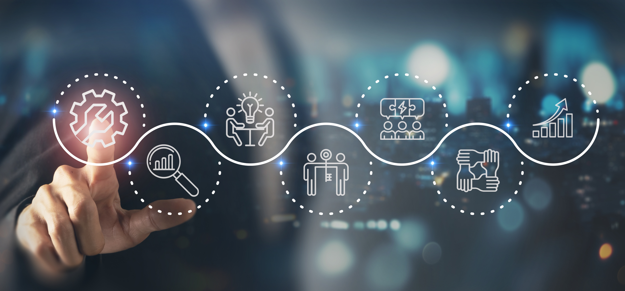 Person's finger touching a glowing gear icon in a digital workflow chain with icons representing analytics, innovation, te...