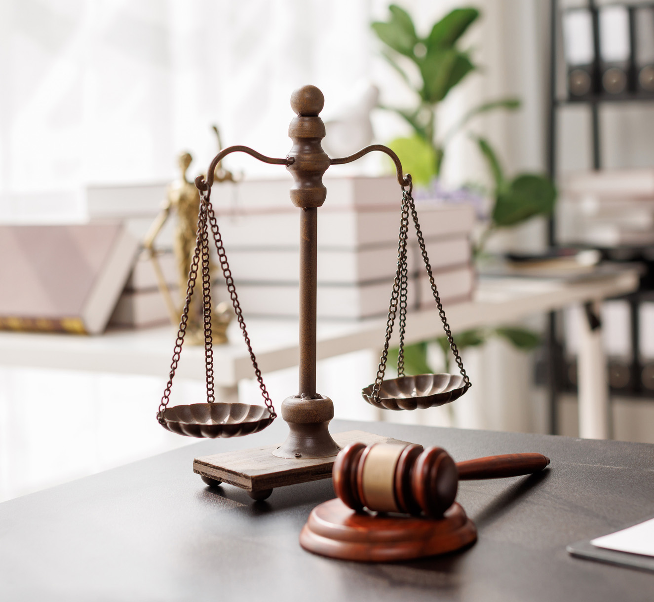 Justice statue, gavel, with LAW Justice lawyers having team meeting at law firm background. Concepts of Law and Legal services.