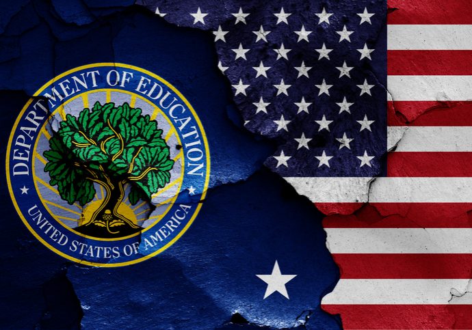 U.S. Department of Education seal with green tree logo beside a cracked American flag painted on a weathered wall surface.