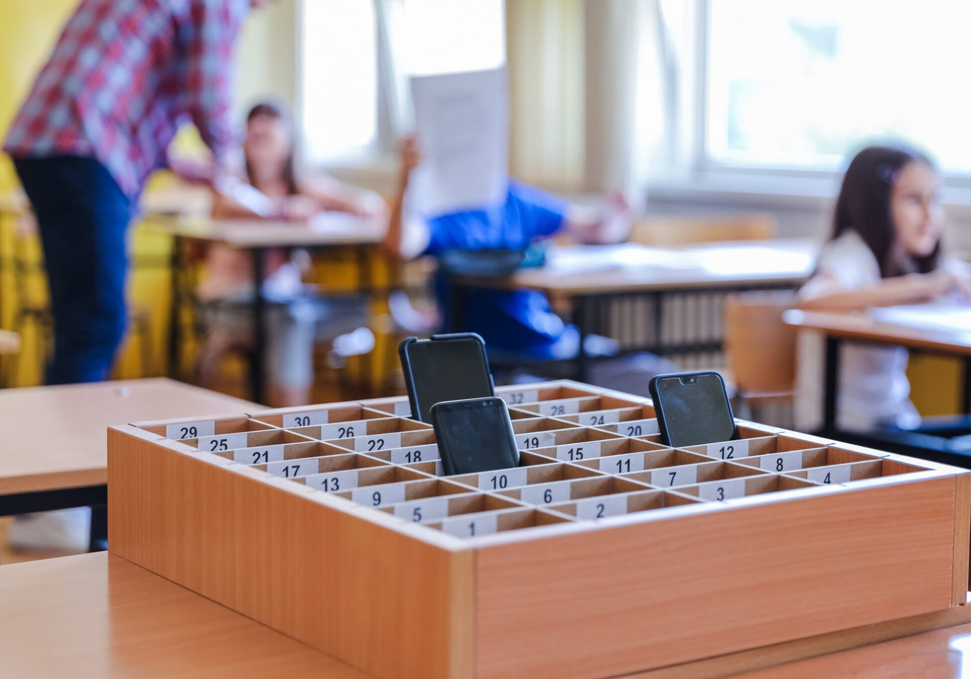 School children leaving their phones at a catalog box during class