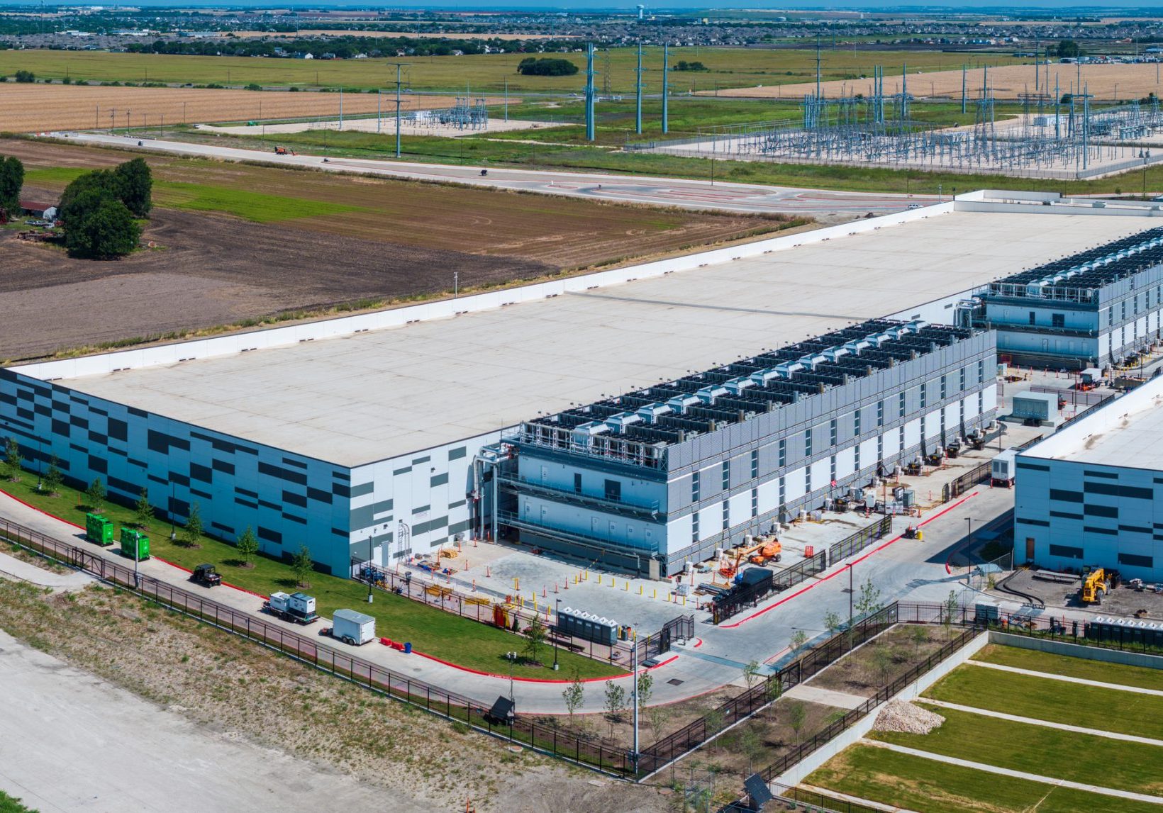 Aerial view of a large data center campus with focus on the processor hosting area and power and cooling infrastructure being built in Hutto TX